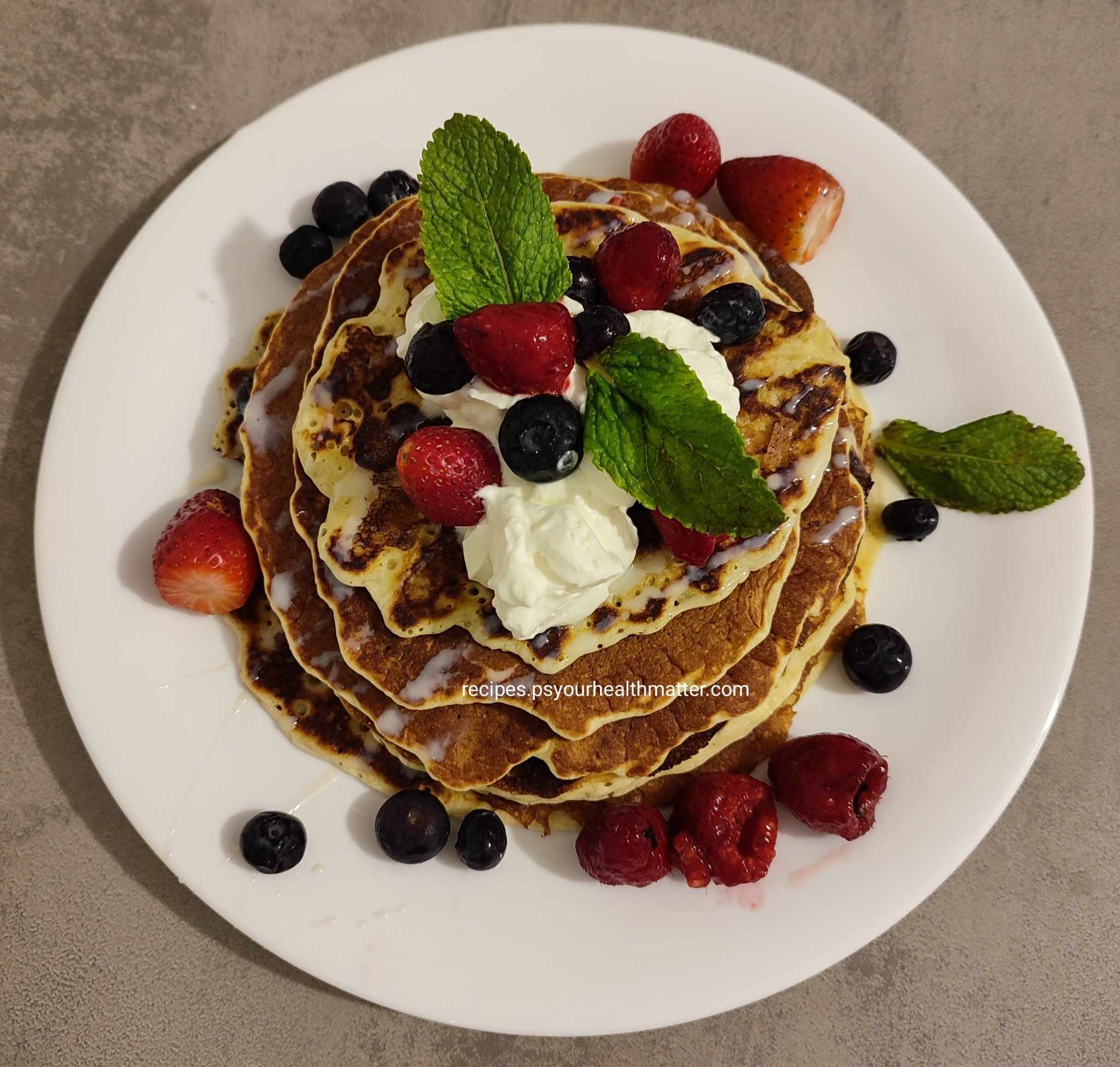 Fluffy Oat Pancakes with Fresh Berry Topping These light and fluffy oat pancakes are a delicious and healthy breakfast or brunch option. Packed with wholesome oats and topped with vibrant fresh berries, they're a delightful way to start your day. About Time: Yields: Makes 12 pancakes Prep time: 20 minutes (plus 20 minutes soaking time) Cook time: 25 minutes Go to the next page to get the Ingredients Ingredients: 2 large eggs, separated 1 cup (240ml) unsweetened almond milk (or your preferred milk) 2 tablespoons granulated sweetener (or to taste), divided 1 teaspoon vanilla extract ½ cup (50g) rolled oats 1 teaspoon baking powder ½ cup (50g) all-purpose flour (or a gluten-free blend) Cooking spray or a little butter for the pan 1 cup (about 150g) mixed fresh berries (such as strawberries, blackberries, blueberries, and raspberries) Optional Berry Sauce: ½ cup (75g) blueberries ½ cup (75g) raspberries 1 tablespoon granulated sweetener Go to the next page to get the Instructions Instructions: Prepare the batter: In a medium bowl, whisk together the egg yolks, almond milk, 1 tablespoon of sweetener, and vanilla extract. Stir in the rolled oats and baking powder. Let the mixture sit for 20 minutes to allow the oats to soften. Combine dry and wet ingredients: In a separate bowl, sift the flour (if using) and then gently fold it into the oat mixture. Be careful not to overmix. Whisk egg whites: In a clean bowl, whisk the egg whites until soft peaks form. Gently fold the egg whites into the oat mixture using a large spoon or spatula. Avoid overmixing, as this can make the pancakes tough. Cook the pancakes: Heat a large non-stick skillet or griddle over medium heat. Lightly grease the pan with cooking spray or a small amount of butter. Cook the pancakes: Pour ¼ cup portions of batter onto the hot griddle, leaving space between each pancake. Cook for about 2-3 minutes per side, or until golden brown and cooked through. Flip the pancakes when bubbles start to form on the surface and the edges look set. Keep warm: As the pancakes are cooked, you can keep them warm in a low oven (around 200°F or 90°C) if desired. Place the cooked pancakes on a plate and cover them loosely with foil or a clean kitchen towel. Prepare the berry sauce (optional): If making the berry sauce, combine the blueberries, raspberries, and 1 tablespoon of sweetener in a food processor or blender and blend until smooth. For a smoother sauce, press the mixture through a fine-mesh sieve to remove the seeds. Serve: Stack the pancakes on plates and top with the fresh berries. Sprinkle with the remaining 1 tablespoon of sweetener. Drizzle with the optional berry sauce, if desired. Tips: For extra flavor, you can add a pinch of cinnamon or nutmeg to the batter. Use any combination of fresh or frozen berries you like. If you don't have almond milk, you can use regular milk, soy milk, or another plant-based milk. For a richer flavor, you can use melted butter instead of cooking spray. Top with a dollop of Greek yogurt or a drizzle of maple syrup for added deliciousness. Enjoy your fluffy oat pancakes