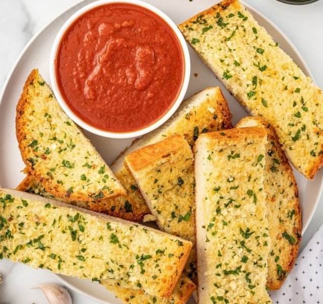 Low Syn Garlic Bread - Perfect for Slimming Craving garlic bread but watching your weight? This recipe delivers all the flavor with just 6 per serving! Made with wholemeal muffins and a simple blend of garlic, lemon zest, and Parmesan, this quick and easy side dish is perfect for any meal. About Time: Serves: 4 Sys per serving: 6 Ready in: 5 mins Ingredients: 50g extra-light spread 2-4 garlic cloves, crushed (to taste) a little lemon zest (from an unwaxed lemon) 2 level tbsp grated fresh Parmesan or vegetarian alternative 2 tbsp chopped fresh parsley 2 x 60g wholemeal muffins Instructions: Combine flavors: In a bowl, mix the spread, garlic, lemon zest, Parmesan, and parsley. Season lightly with salt and pepper. Prepare the bread: Split the muffins in half and toast them lightly. Spread the goodness: Evenly spread the garlic mixture on the toasted muffin halves. Enjoy! Tips: For extra flavor, use fresh parsley instead of dried. If you don't have wholemeal muffins, you can use wholemeal bread instead. This recipe is a great way to use up leftover garlic. Serve this garlic bread alongside your favorite soup or salad.