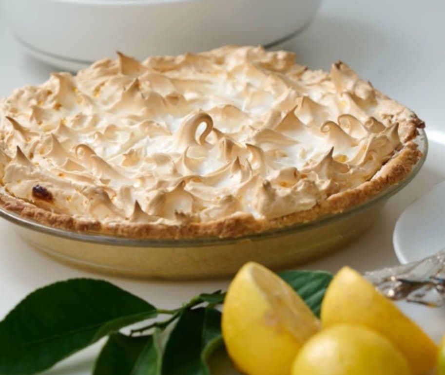 Lemon Pie Recipe Craving a tangy and refreshing dessert that won't completely derail your Slimming World plan? Look no further than this delightful Lemon Pie! We've swapped the traditional pastry crust for a lighter and equally delicious biscuit base, creating a treat that satisfies your sweet tooth without the guilt. The creamy lemon curd filling, topped with a cloud of airy meringue, is baked to golden perfection. This recipe is perfect for a special occasion or simply a well-deserved treat. About Time Yield: 2 servings Prep Time: 20 minutes Cook Time: 20-25 minutes (including curd and meringue baking) Ingredients: Base: 8 Bourbon cream biscuits, finely crushed 40g low-fat spread, melted Curd: Zest and juice of 2 lemons 2 eggs + 2 egg yolks (save whites for meringue) 2 tbsp sweetener (adjust to taste) 2 tsp Clover Light butter Meringue: 25g caster sugar 2 egg whites (from the curd) Instructions: Preheat oven to 160°C fan. Base: Combine crushed biscuits and melted low-fat spread. Press into the bottom of two small oven-safe dishes or ramekins. Consider lining the dishes with parchment paper for easier removal. Curd: Whisk eggs, yolks, sweetener, lemon zest, and juice in a heat-resistant bowl. Place the bowl over a pan of simmering water (bain-marie), ensuring the bowl doesn't touch the water. Continuously whisk until the curd thickens. This will take about 10-15 minutes. Don't stop whisking to avoid scrambling. Remove the curd from the heat and set aside to cool slightly. Meringue: In a clean, grease-free bowl, whisk egg whites until soft peaks form. Gradually add the caster sugar, whisking until stiff, glossy peaks form. Over-whisking can make the meringue weep. Divide the lemon curd between the prepared dishes (on top of the biscuit base). Spoon or pipe the meringue over the curd. Bake for 10-15 minutes, or until the meringue is golden brown and slightly crisp. Allow to cool before serving. It can be eaten warm (carefully, as it will be hot) or chilled in the fridge.