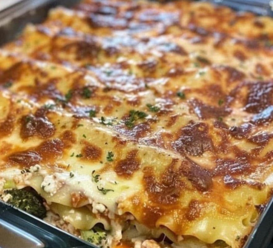 Broccoli Pesto Chicken Lasagna Lasagna. The ultimate comfort food. But often, it's loaded with calories and fat. Not this one! Broccoli Pesto Chicken Lasagna delivers all the flavor and satisfaction you expect from a great lasagna, but with a fraction of the syns. We've swapped out the heavy ingredients for lighter alternatives, without sacrificing any of the deliciousness. Think vibrant pesto, tender chicken, and a creamy (but light!) Alfredo-style sauce, all layered between tender pasta. It's the perfect dish for a cozy night in! About Time: Yields: 8-10 servings Prep time: 30 minutes Cook time: 40 minutes Go to the next page to get the Ingredients Ingredients: Broccoli Pesto: 2 cups broccoli florets (tops only) 1 ½ cups basil leaves Low-calorie cooking spray 2 garlic cloves Salt and pepper Reduced-fat Parmesan (optional, calculate syns) Alfredo-Style Sauce: Low-calorie cooking spray 2 tbsp flour 3-4 garlic cloves, minced Fat-free quark or quark/light cream cheese blend (calculate syns) Skim milk or unsweetened almond milk 1 ½ cups low-sodium chicken/vegetable broth 1 tsp dried basil Salt and pepper Lasagna: 2 ½ cups cooked shredded skinless chicken breast Reduced-fat mozzarella (calculate syns) or reduced-fat mozzarella/quark blend 1 ½ cups Broccoli Pesto No-boil lasagna noodles (check syns) Go to the next page to get the Instructions Instructions: Preheat oven to 375°F (190°C). Broccoli Pesto: Combine all pesto ingredients in a food processor. Blend until smooth, using minimal oil or low-calorie cooking spray. Season to taste. Set aside. Alfredo-Style Sauce: Spray a saucepan with low-calorie cooking spray. Sauté minced garlic until fragrant. Stir in flour. Gradually whisk in milk and broth. Add quark (and light cream cheese, if using), basil, salt, and pepper. Simmer until thickened. Set aside. Assemble: Spread a thin layer of Alfredo-style sauce in a 9x13 inch dish. Layer noodles, Alfredo-style sauce, pesto, chicken, reduced-fat Parmesan (if using), and mozzarella (and quark, if using). Repeat layers. Top with remaining noodles, sauce, and mozzarella. Bake: Bake uncovered for 20 minutes. Cover with foil and bake another 20 minutes, or until cheese is melted. Rest: Let stand 5-10 minutes before serving.